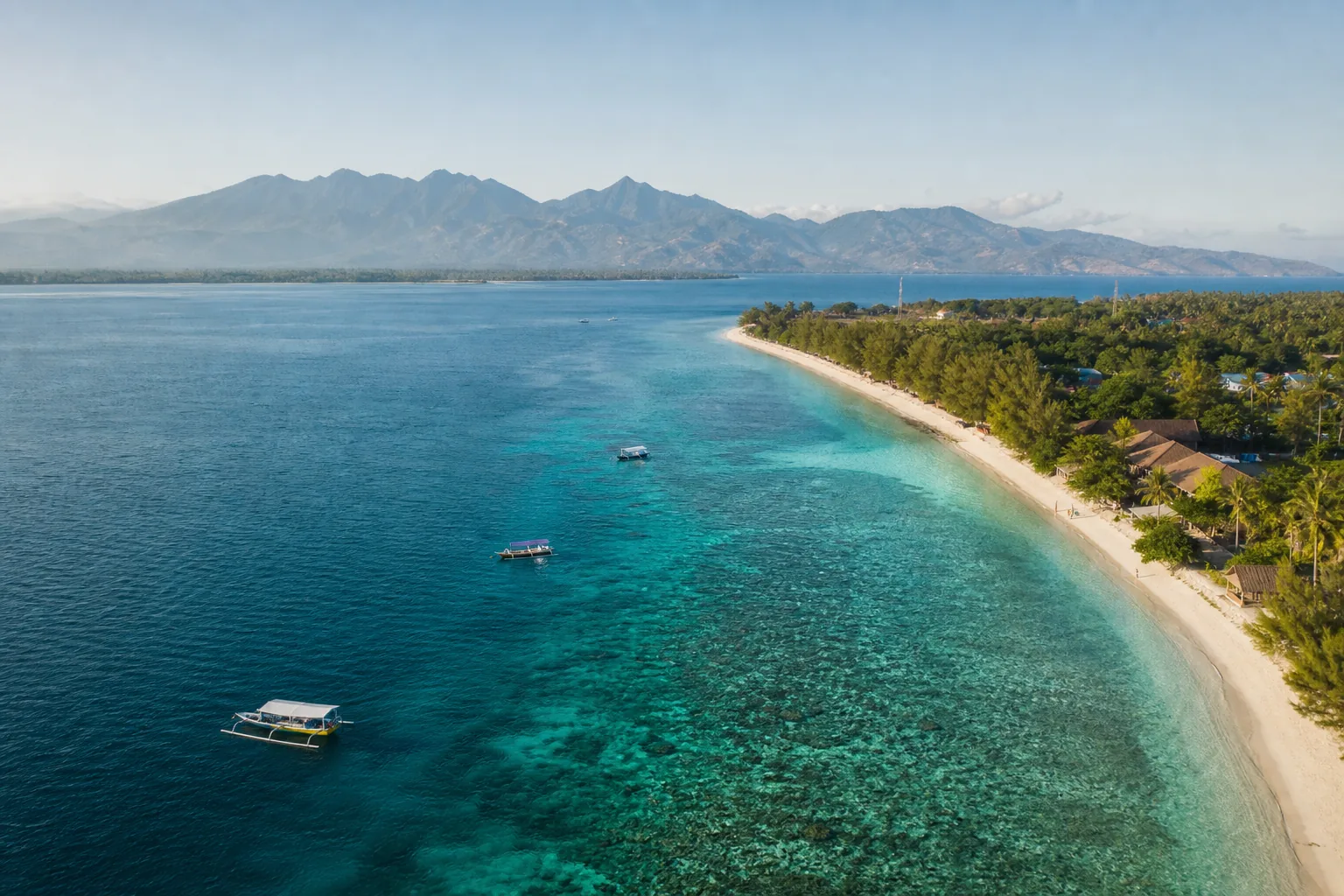 Bright tropical weather over clear turquoise water in the Gili Islands